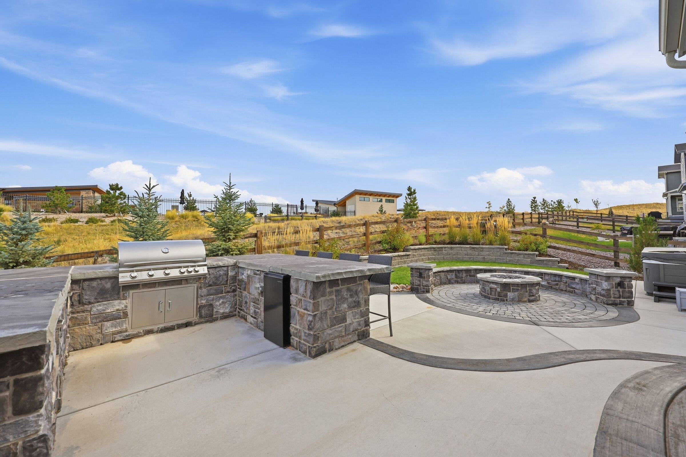 The stone outdoor kitchen and fire-pit terrace