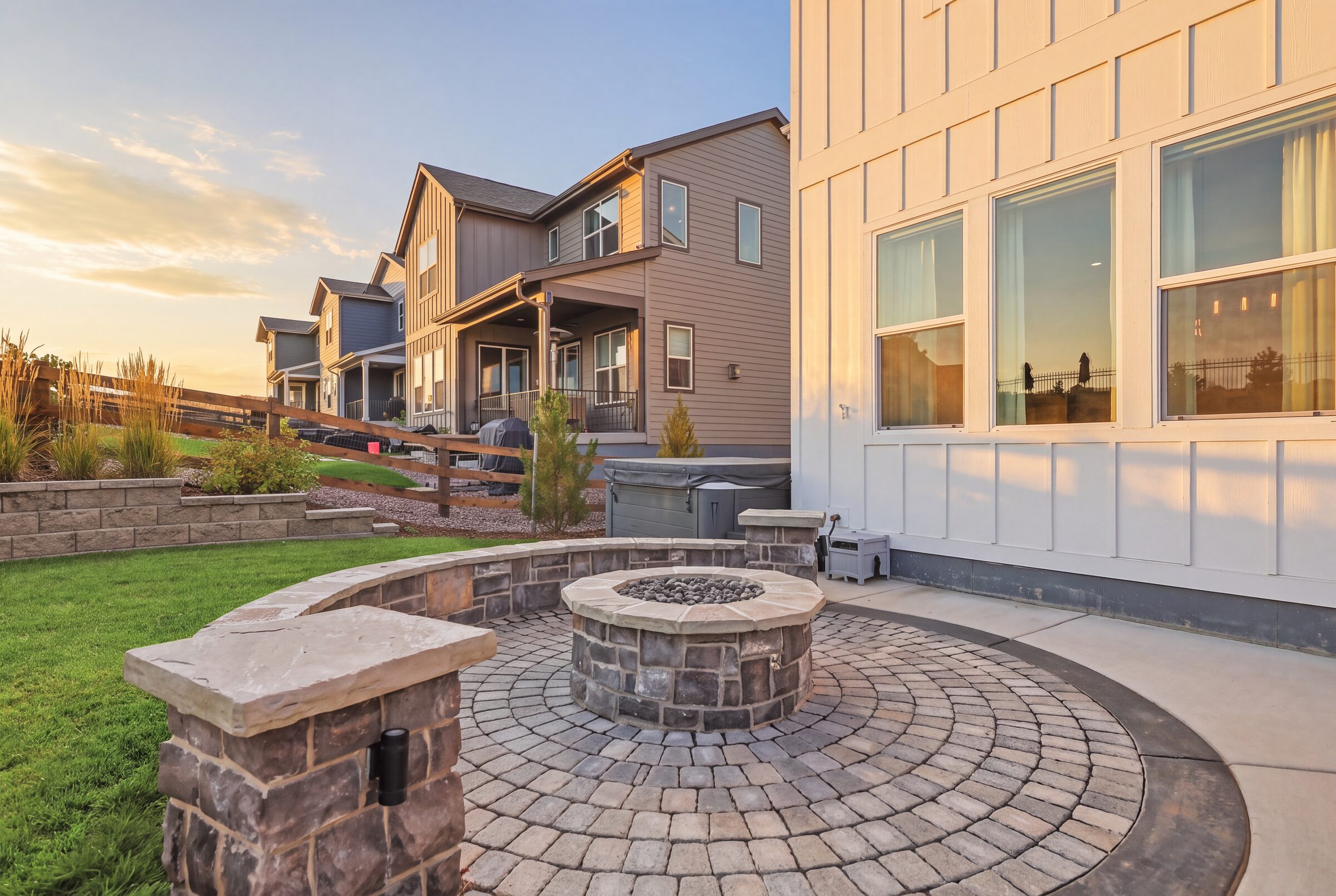 The fire-pit terrace and the back of 4870 Saddle Iron Road at twilight